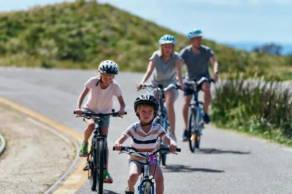 Family cycling along the coast